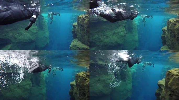 浮潜者探索冰岛构造板块之间的结晶水