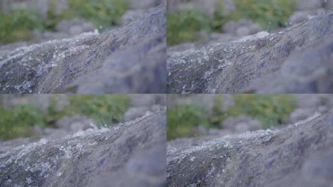 在岩石山坡上流水的详细镜头