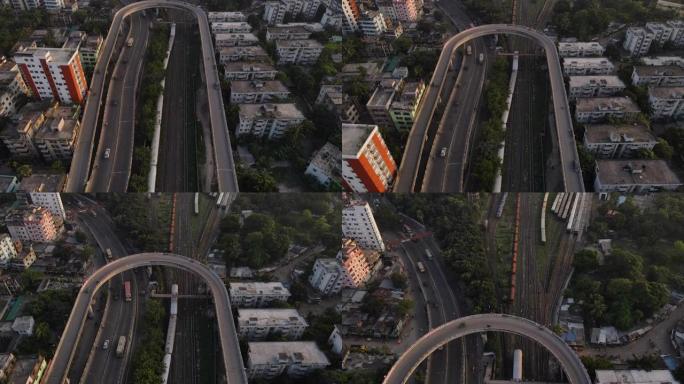 高速公路环线天桥与城市建筑之间的铁路线相交。空中自上而下的无人机飞行向前射击
