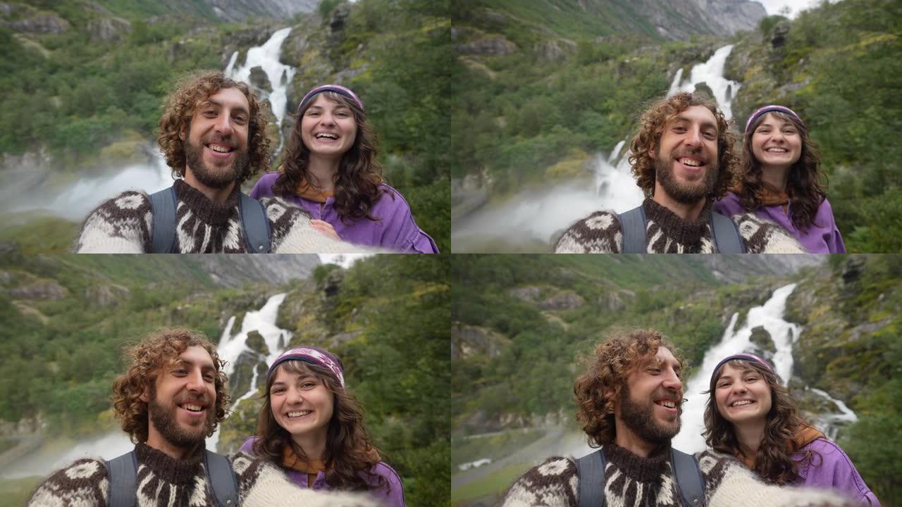 挪威山瀑布背景下的男人和女人自拍