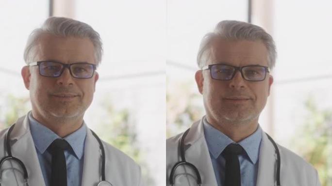 垂直肖像中年医疗保健专业人员摆姿势，微笑和看着相机。戴眼镜、穿白大褂的白种人门诊医生在医院办公室工作