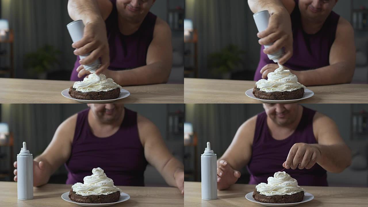 胖胖的男性用鲜奶油装饰蛋糕，并将樱桃放在顶部