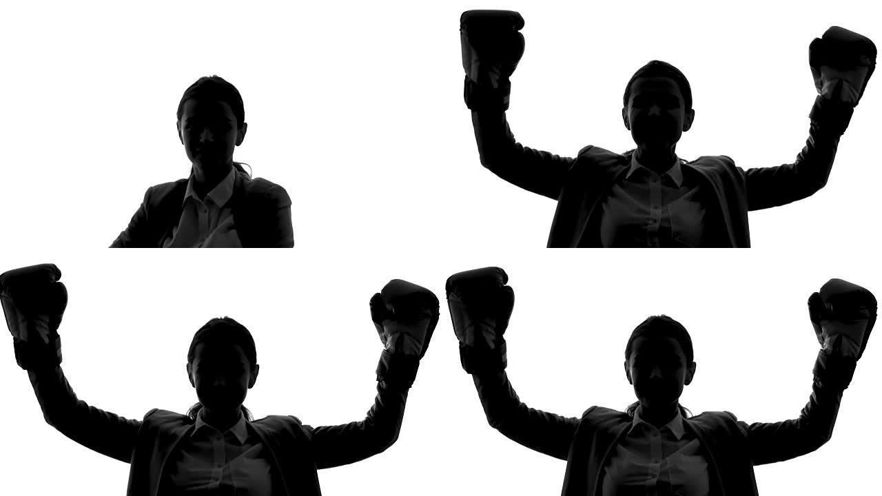 穿着拳击手套的女商人表现出成功的姿态，解放，职业