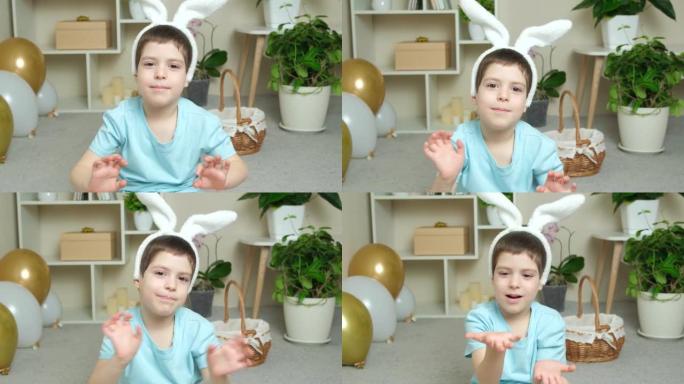 一个头上有兔子耳朵的学龄前复活节男孩向镜头里挥手打招呼，唱歌。