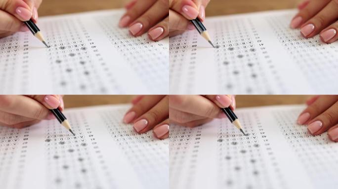 考试时，女子手持铅笔批改试题答案