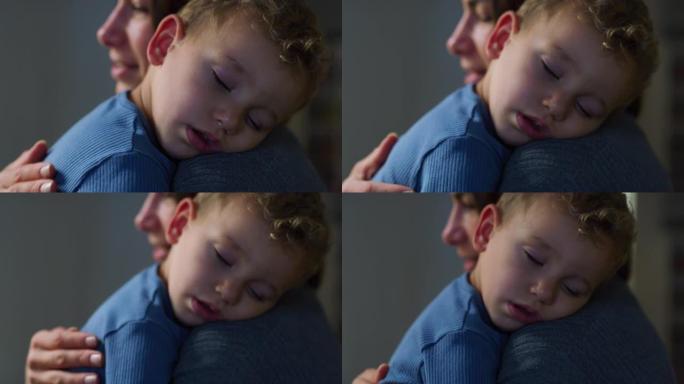 一个年轻女子在家里给熟睡的儿子唱摇篮曲的肖像。深情的母亲让她的男小孩入睡，揉着他的背，用温柔的歌声抚