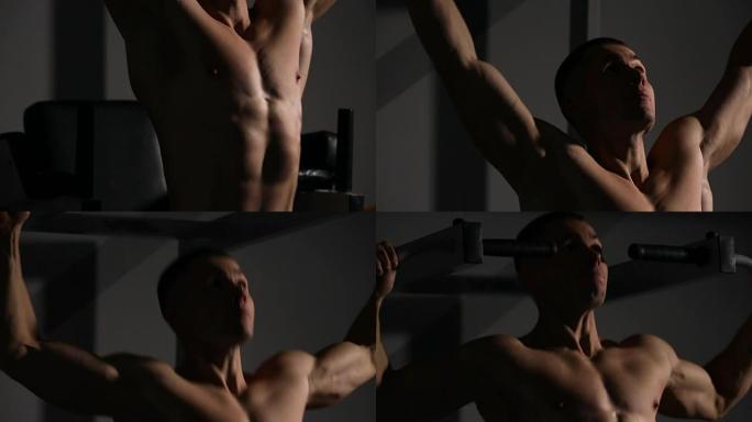 轧辊男子在健身房表演引体向上特写。你可以看到所有的肌肉