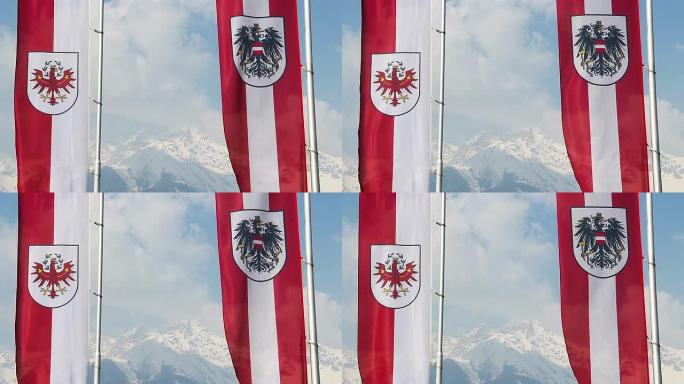 蒂罗尔 (Tyrol)，奥地利国旗挥舞着，背景上雄伟的白雪皑皑的阿尔卑斯山