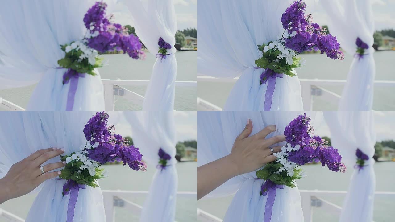 女手摸一幅白色婚礼用鲜花窗帘