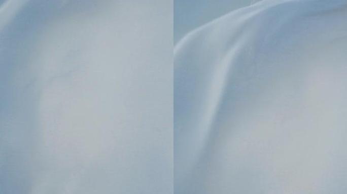 白色透明织物在风中挥舞垂直视频