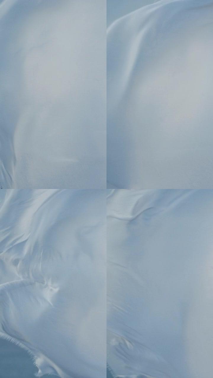 白色透明织物在风中挥舞垂直视频