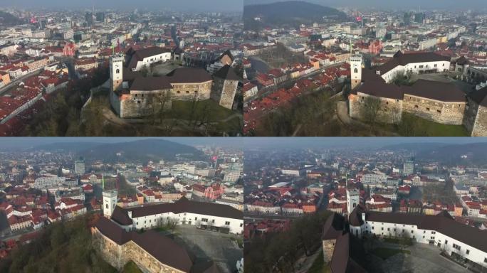 晴天在城市上方的卢布尔雅那城堡进行空中无人机拍摄