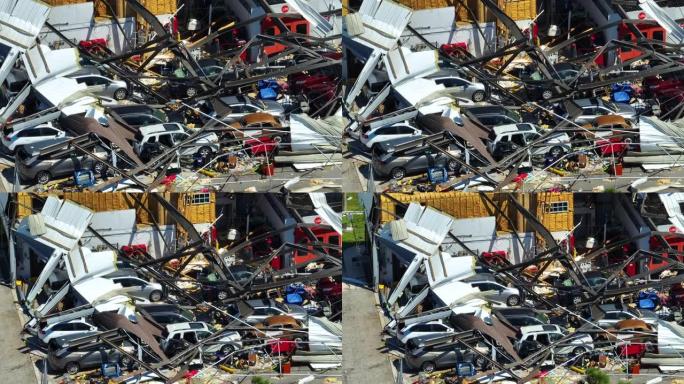飓风伊恩摧毁了佛罗里达州废墟下损坏的汽车的工业建筑。自然灾害及其后果