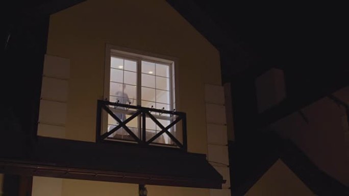 Happy young girl jumps on bed near the window