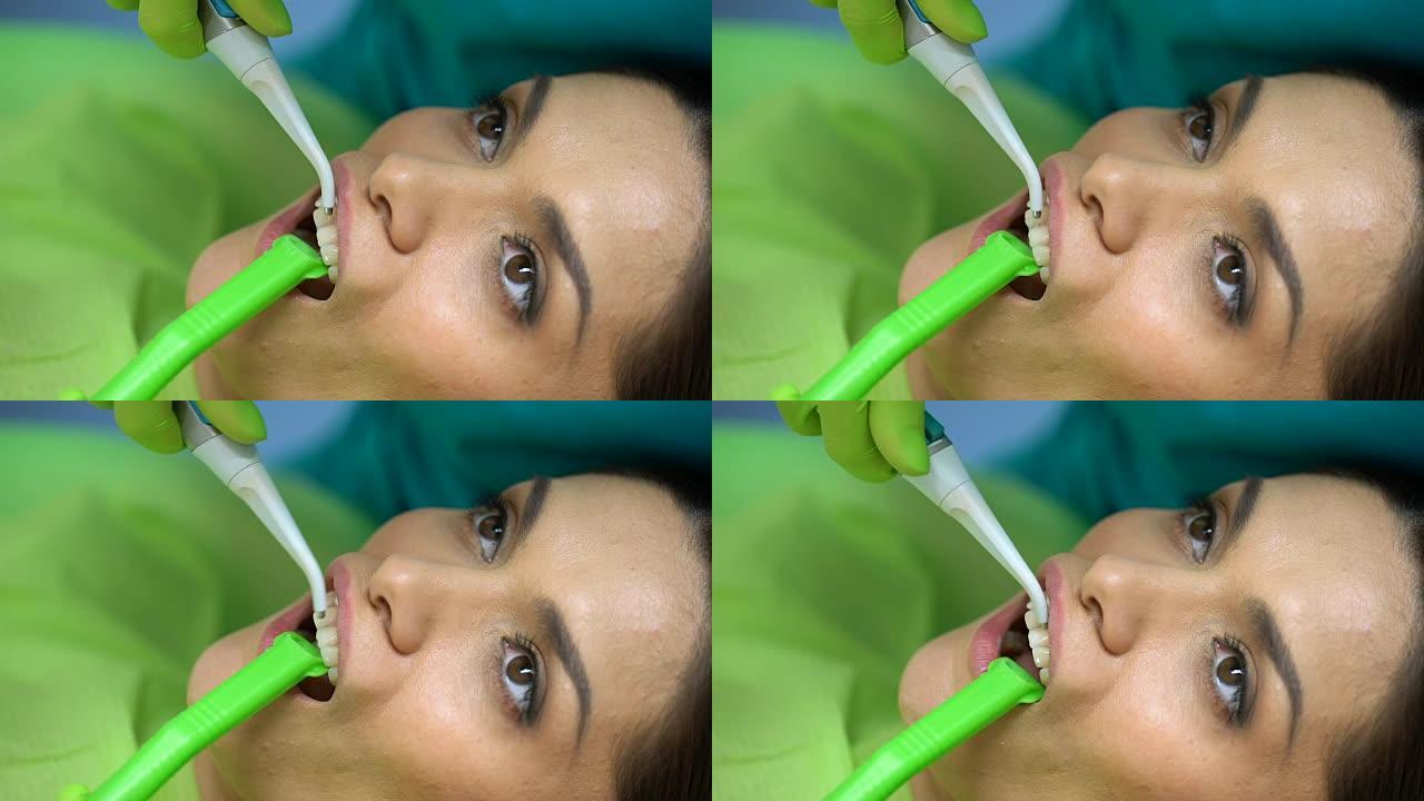 牙医从牙齿清洗蓝色凝胶，美容牙科，专业帮助