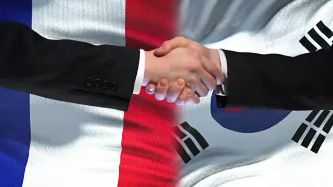法国和韩国握手，国际友谊，国旗背景