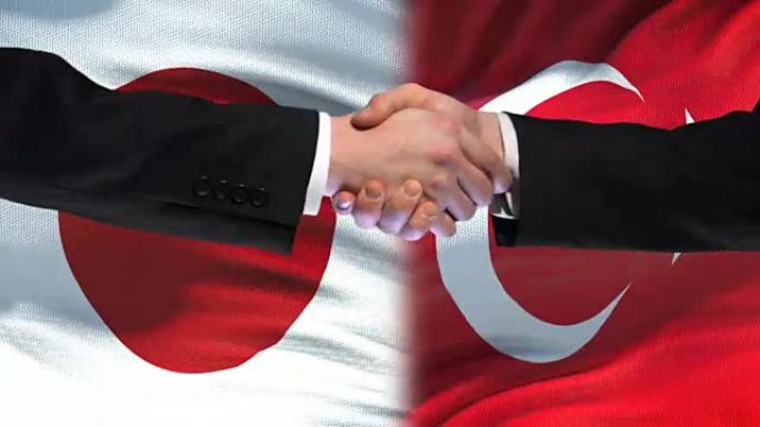 日本与土耳其握手，国际友好关系，旗帜背景