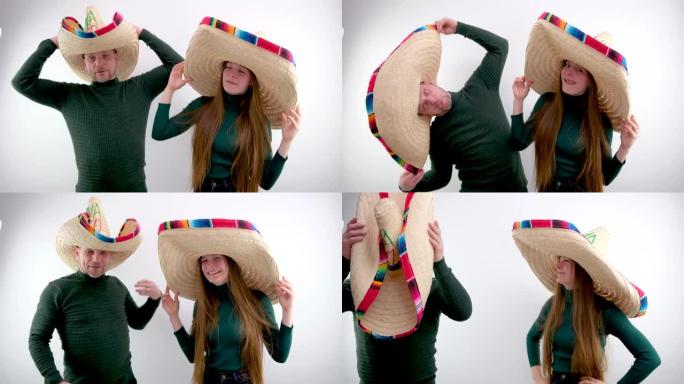 男人和一个女孩做鬼脸伸出舌头做鬼脸他们在白色背景上戴着巨大的草帽墨西哥颜色传统搞笑照片广告旅游娱乐嗡