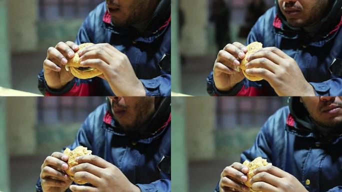 男子在快餐店吃汉堡，不健康的饮食危险