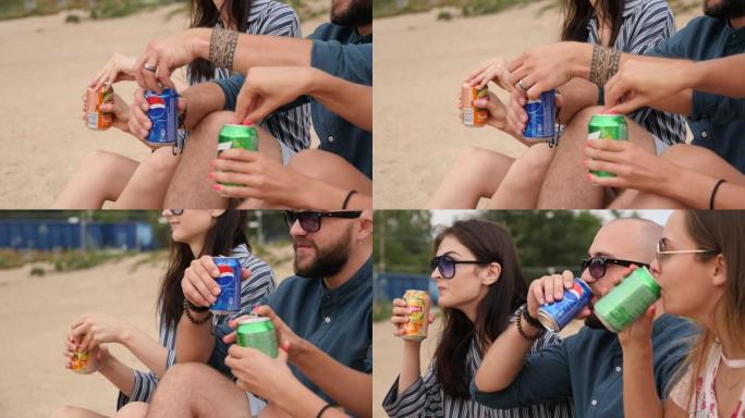 打开罐碳酸饮料年轻人朋友喝酒闲逛坐在大自然的沙滩上