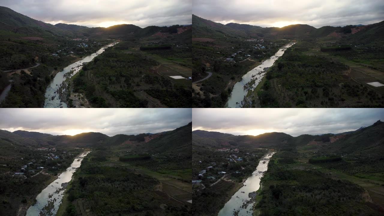日落后的越南河流在小镇附近，空中无人机