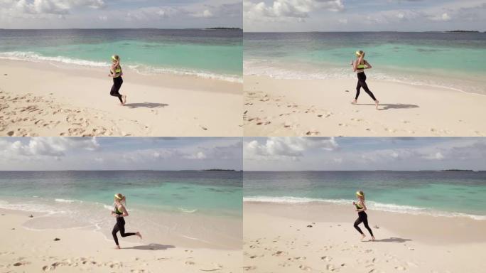 年轻女子沿着海岸线慢跑的空中跟踪镜头。跑步活动是一种非常受欢迎的健康生活方式