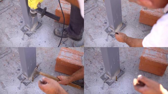 工地建造者的工人用锤子击碎钻混凝土