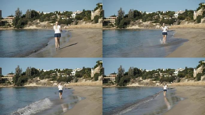 年轻女子听音乐，沿着海边的海滩奔跑