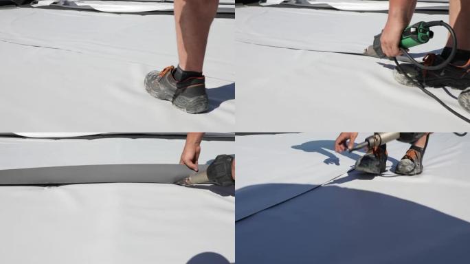 屋顶工用热风枪焊接合成聚氯乙烯薄膜。