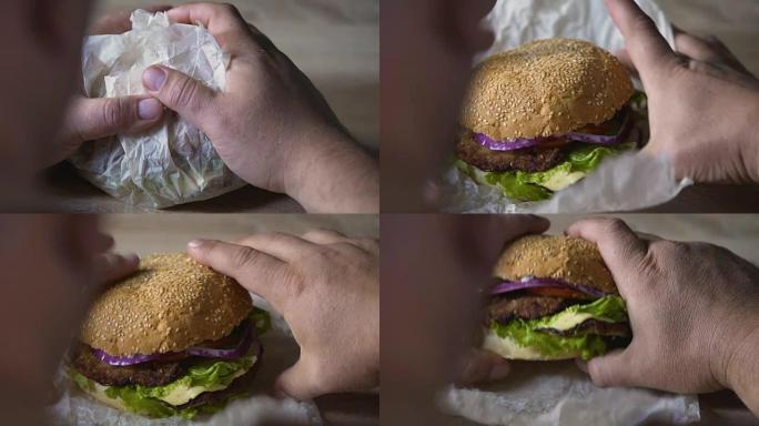 背景式的人咬大油腻汉堡，不健康的饮食习惯，特写