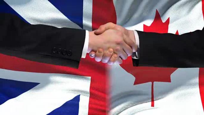 英国和加拿大握手，国际友谊，旗帜背景