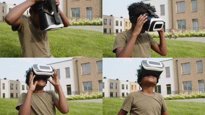年轻的黑人男孩在户外尝试VR耳机