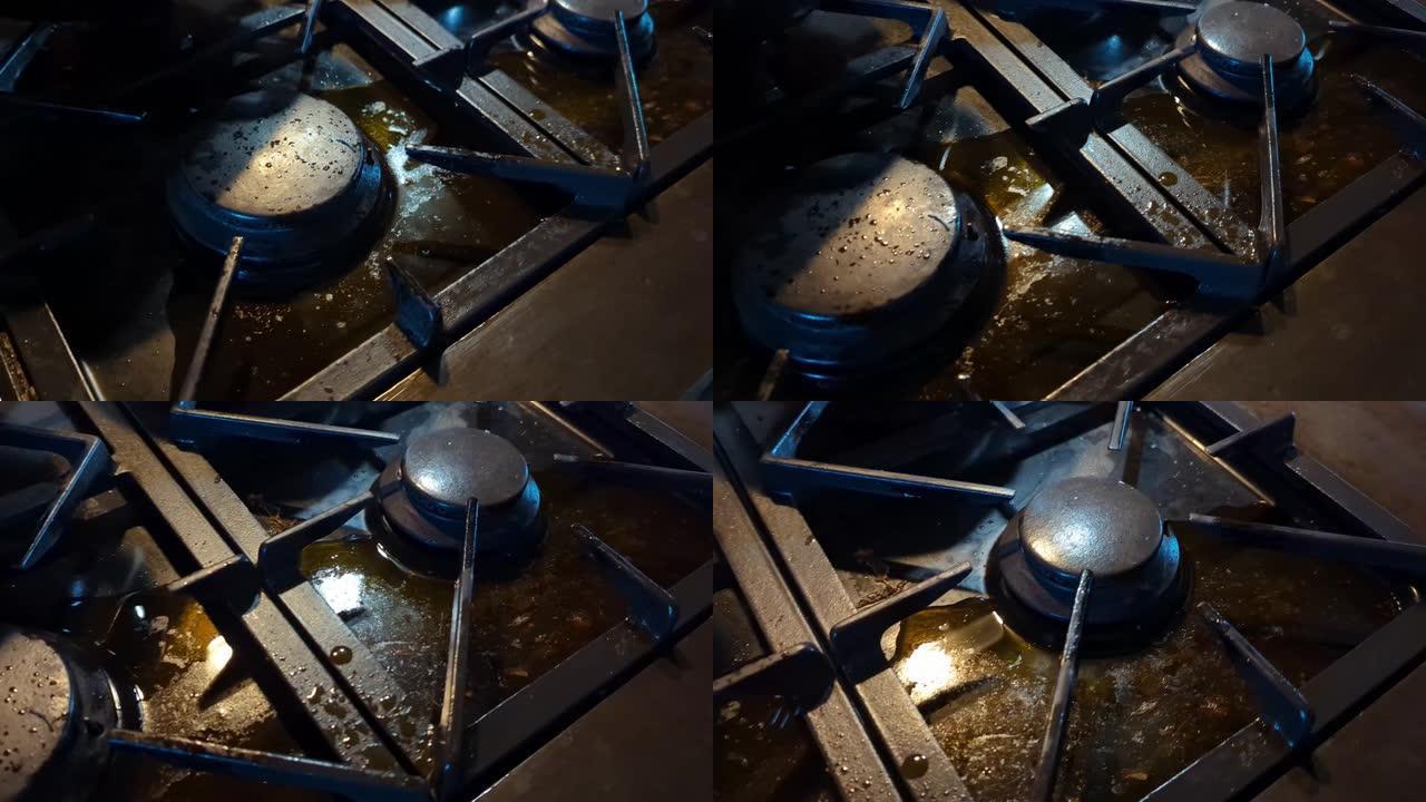 溢出液体的肮脏厨房炉子。需要清洁的深色滚刀。
