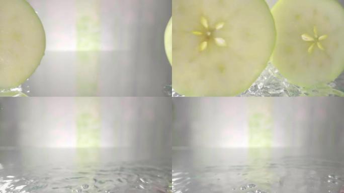 在白色背景上滚动苹果水果片。慢动作镜头