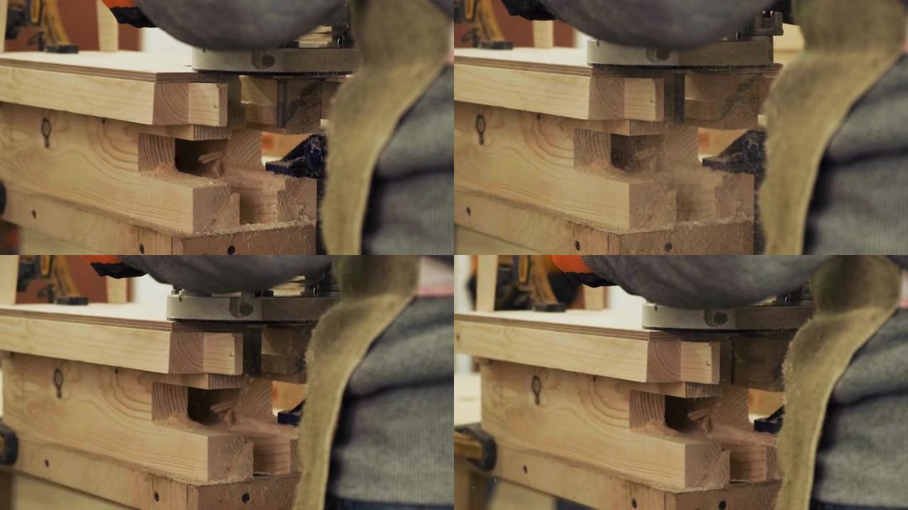 木工车间手工铣床的木匠。电动木材路由器生产家具元件。