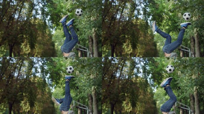 专注于一个才华横溢的年轻足球运动员的腿，他仰卧时熟练地玩弄球。时尚的男人在公园里展示他的自由式足球技