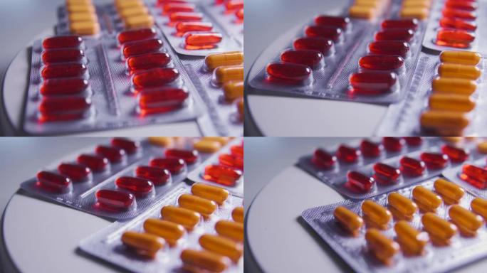 特写药品水泡用橘红色胶囊躺在桌子上，制药公司从事生产具有活性成分的新药，广告