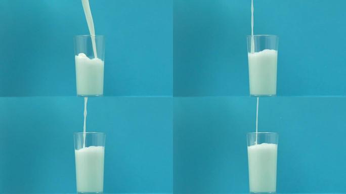 在蓝色背景上倒入玻璃中的新鲜牛奶，钙和磷的来源