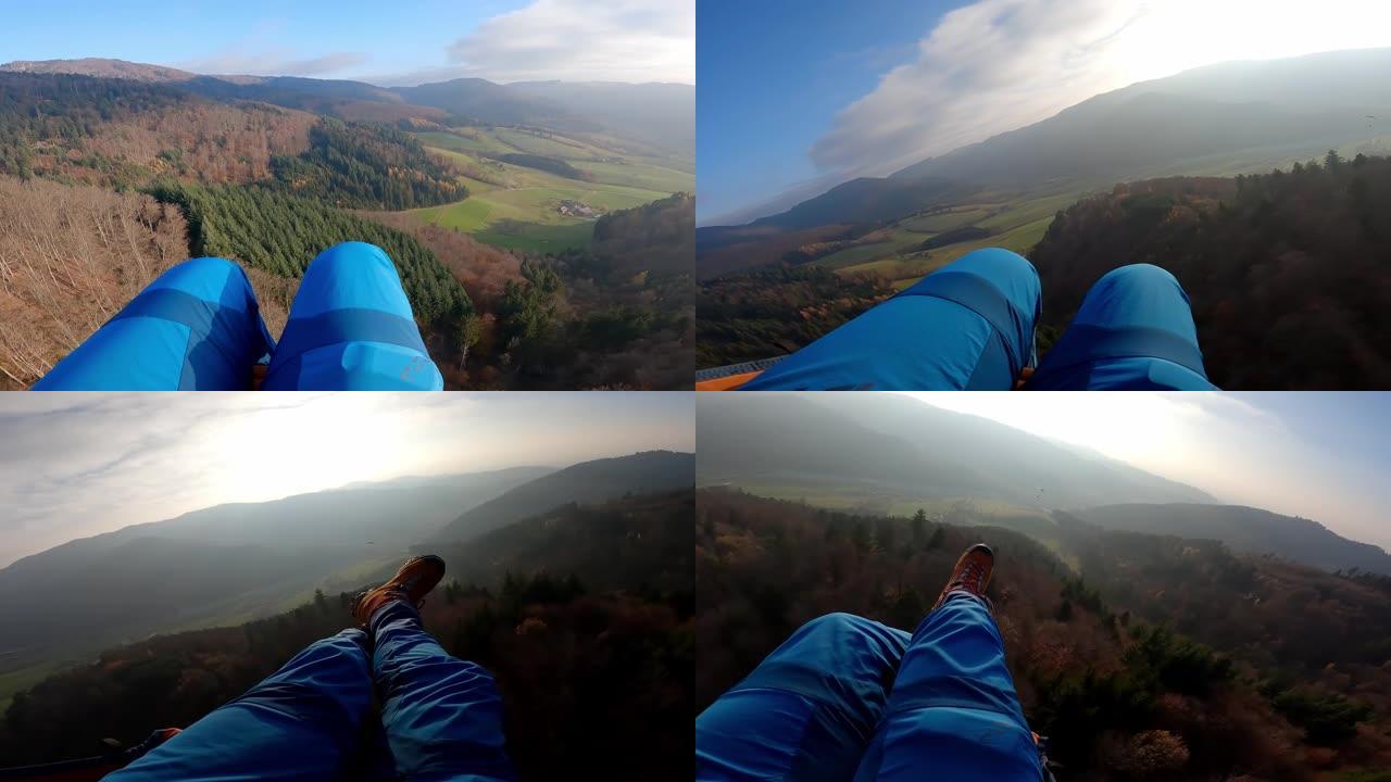 滑翔伞飞越森林山丘的前视图