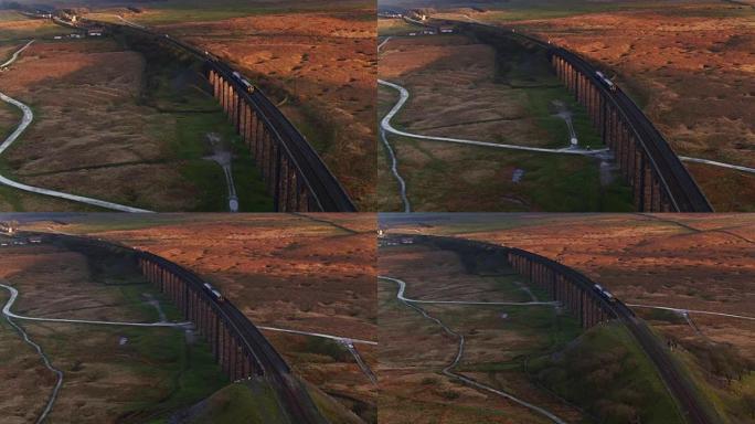 日落时分，火车穿过里布尔海德高架桥——无人机拍摄