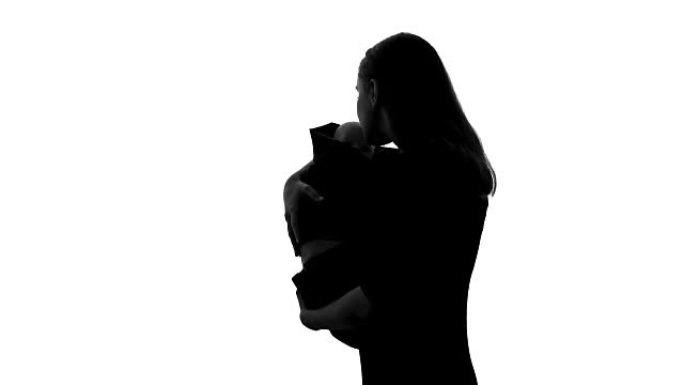 女人抱着娃娃作为自己的孩子，为失去的新生儿感到悲伤，堕胎