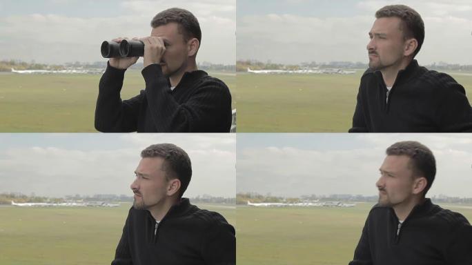 带双筒望远镜的年轻人在机场观看飞机后