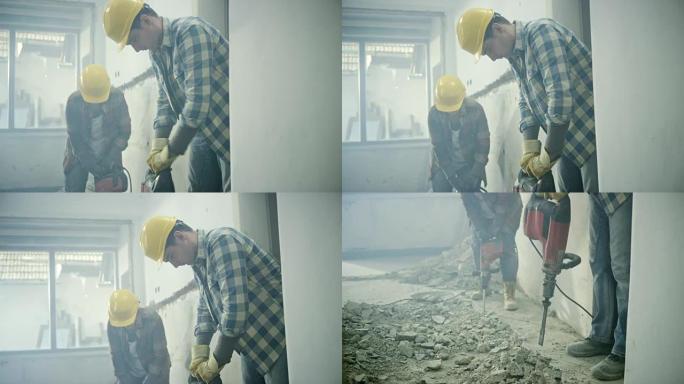 用手提凿岩机拆除房屋地板的工人