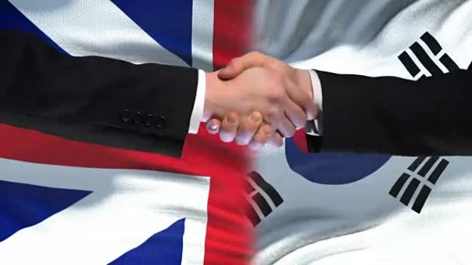英国和韩国握手国际友谊旗帜背景