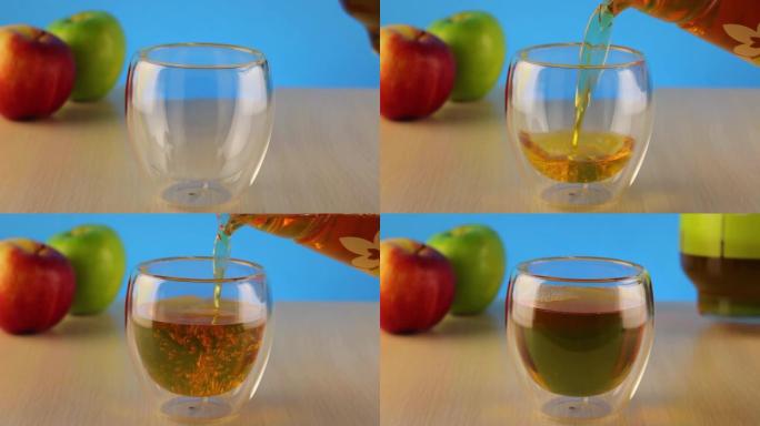 将玻璃壶中的苹果汁倒入玻璃中。