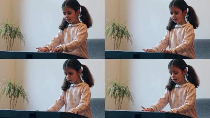 一个小女孩弹电钢琴。
