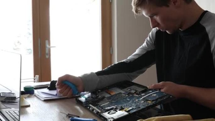 年轻人进行计算机维修，室内设置