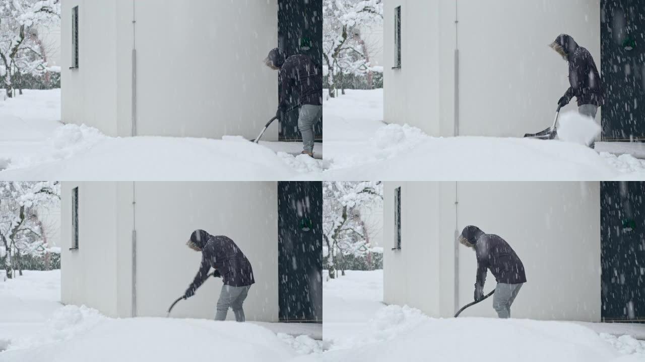 LD男子在大雪中在屋前铲雪
