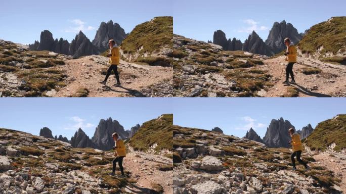 好奇的女人走上巨型山丘，探索意大利阿尔卑斯山