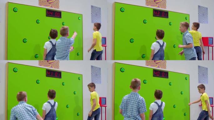 三个男孩在科学博物馆玩反应速度的游戏